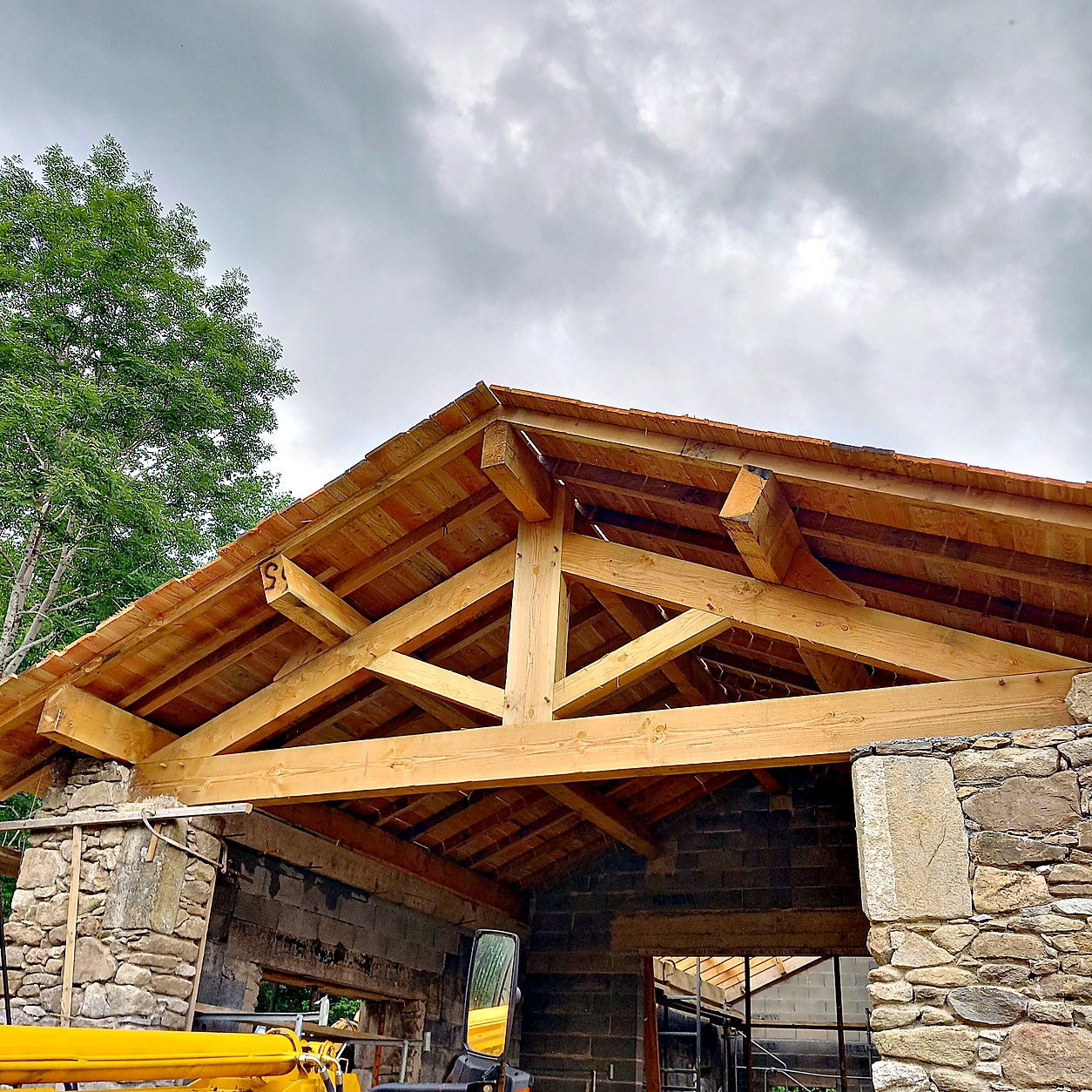 Ferme de charpente traditionnelle assemblée en bois massif sur bâtiment en pierre — SNBD Vieu